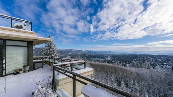 Fototapeta Snow on rooftop patio overlooking Fraser Valley, BC, Canada on a sunny winter day.