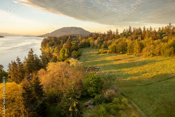 Obraz Aerial view of the east side of Lummi Island during a beautiful sunrise over the Curry Preserve.  Located in the Salish Sea with Lummi Mountain in the background and Hale Pass to the east.