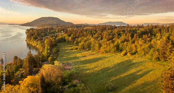 Obraz Aerial view of the east side of Lummi Island during a beautiful sunrise over the Curry Preserve.  Located in the Salish Sea with Lummi Mountain in the background and Hale Pass to the east.