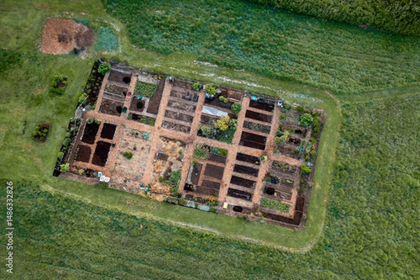 Obraz Aerial view of a Community garden located on an island in the Pacific Northwest. Beautiful morning light illuminates a garden area set aside on a land preserve in the Salish Sea area of Washington.