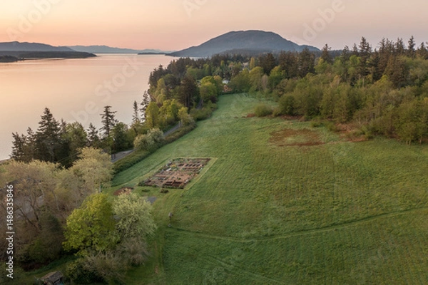 Obraz Aerial view of the east side of Lummi Island during a beautiful sunrise over the Curry Preserve.  Located in the Salish Sea with Lummi Mountain in the background and Hale Pass to the east.