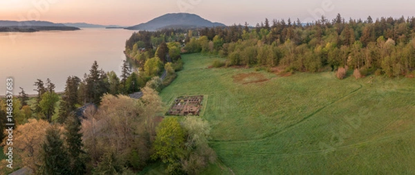 Obraz Aerial view of the east side of Lummi Island during a beautiful sunrise over the Curry Preserve.  Located in the Salish Sea with Lummi Mountain in the background and Hale Pass to the east.