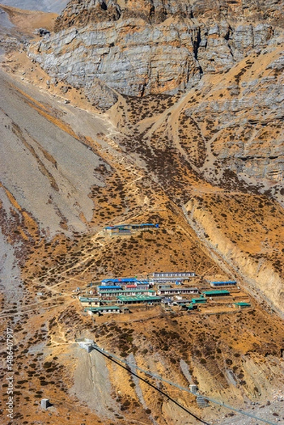 Obraz Thorung Phedi, a group of guesthouses on the steep mountain slope near Thorong La pass, in autumn. Himalaya mountains, Nepal.