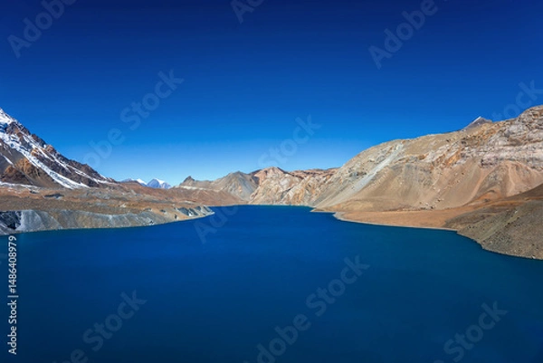 Obraz Still blue lake under the clear blue sky. Tilicho lake in calm weather in autumn sunny day. A sacred lake in Himalaya mountains near Manang, Nepal.