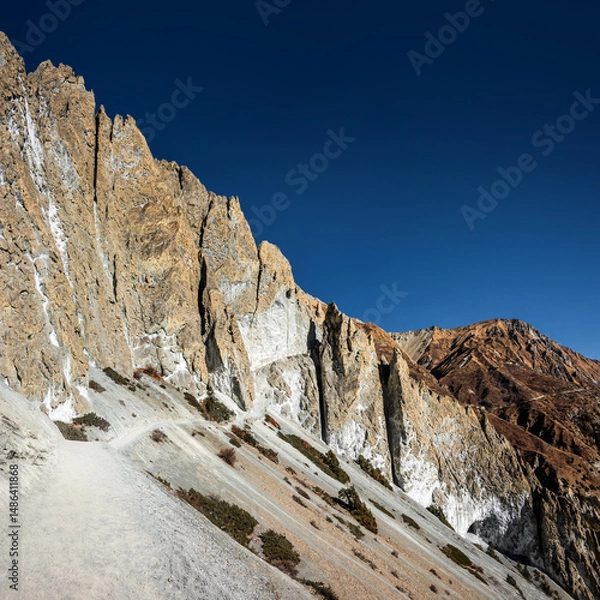 Obraz Trekking route to Tilicho base camp among very steep vertical rock formations in a landslide area. Annapurna circuit trek in Himalaya mountains, Nepal.