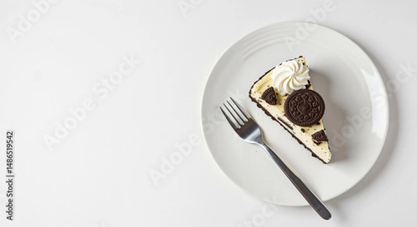 Fototapeta Top view of cookies and cream cheesecake slice with fork with copy space