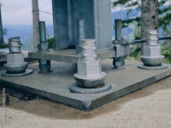Fototapeta Metal pillar fasten to basement with anchor bolts and nuts. Supporting structures, metal frame of prefabricared building