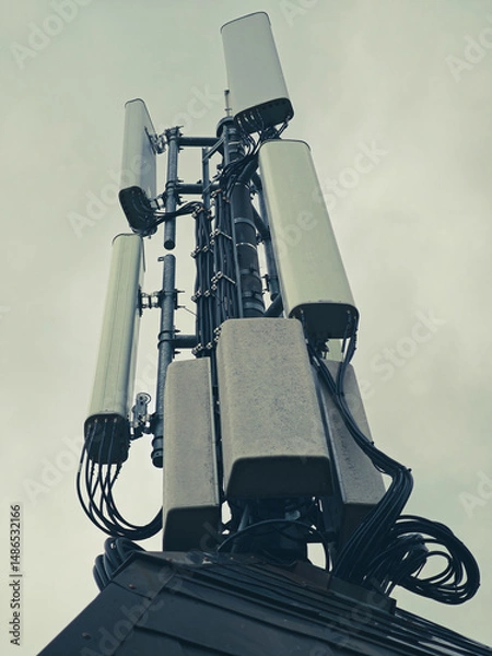 Fototapeta Vertical shot of the satellite tower on a foggy day