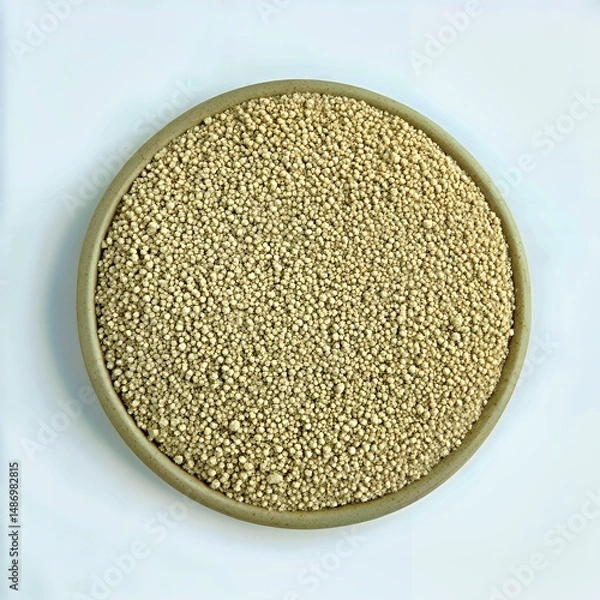 Obraz A close-up view of a bowl filled with tiny quinoa seeds against a clean background.