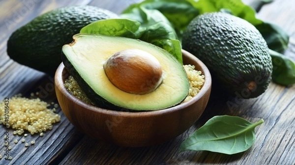 Fototapeta Still life of fresh avocados, spinach and quinoa on wooden table background