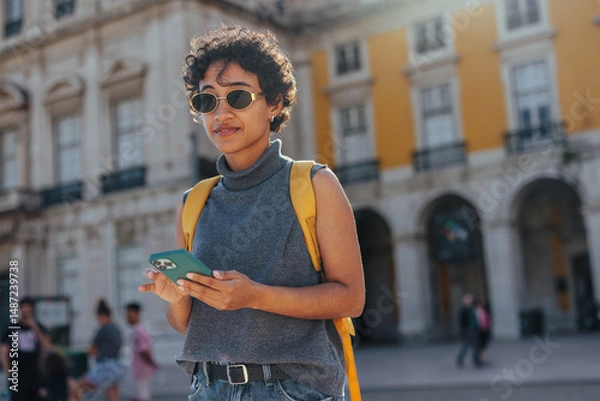 Fototapeta Young tourist using a smart phone in lisbon, portugal