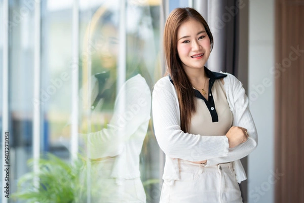 Obraz Portrait of beautiful happy Smiling asian woman relaxing sitting in cafe interior in coffee shop background