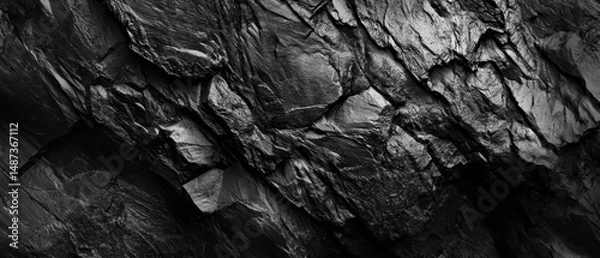 Fototapeta Black textured rock surface background for design, natural stone pattern, abstract geology, dark mineral wallpaper, rugged stone detail for creative projects.