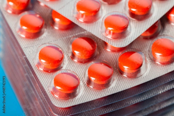 Fototapeta Stack of red pills, macro. Anti-inflammatory and immunomodulatory drug to improve immunity, enzymes of animal origin, lipid metabolism