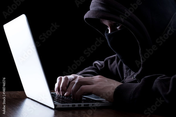 Fototapeta Anonymous hacker in the dark