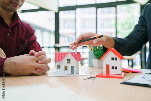 Obraz Professional Real Estate Agent Presenting Property Options To Happy Couple