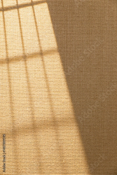 Fototapeta A window of sunlight shining on sisal carpet. Sisal carpet texture background.