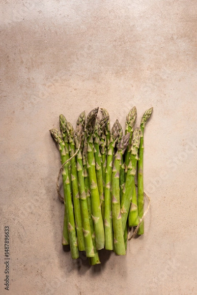 Fototapeta Bunch of fresh green asparagus on stone surface
