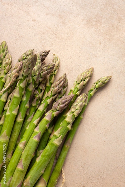 Fototapeta Top view of Fresh green asparagus on stone surface
