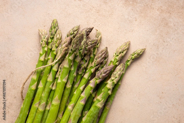 Fototapeta Top view of Fresh green asparagus on stone surface vegan food