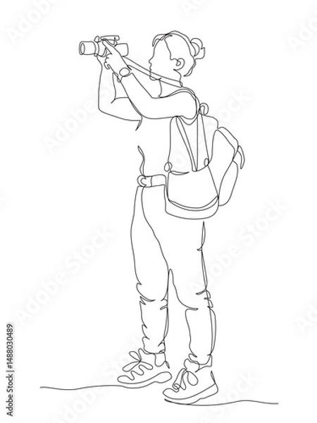 Fototapeta Woman photographer with photo camera and backpack taking picture. Continuous line drawing. Black and white vector illustration in line art style.