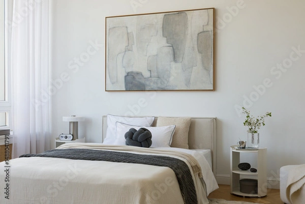 Obraz Modern bedroom scene with a knot pillow, monochrome bedding, and light-filled atmosphere, styled with minimal decor elements.