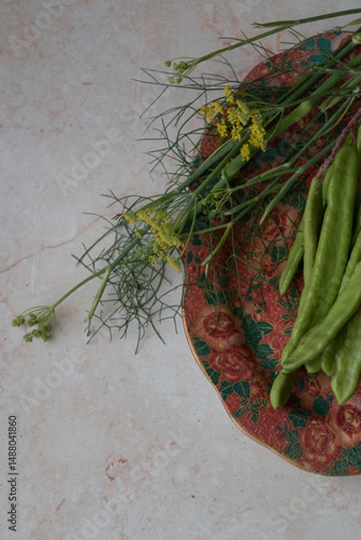 Obraz Green carob beans and fennel on textured background. Perfect for farming presentations, botanical visuals, or crop diversity promotions.