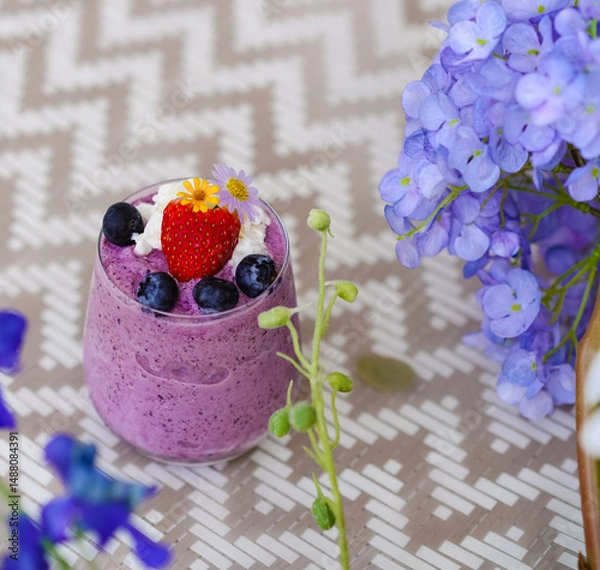 Fototapeta Berry Yogurt Smoothy. A closed up Top view of berry yogurt milkshake including starberry and blueberries on top. Diet and healthy drink. Summer refreshment.