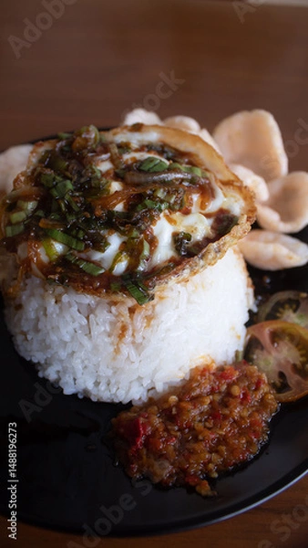 Fototapeta Rice with Fried Egg, Sweet Soy Sauce, and Crackers