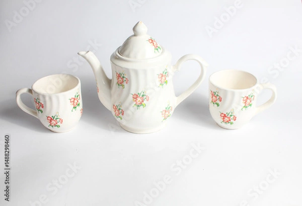Fototapeta white ceramic teapot and cup with floral pattern isolated on white background