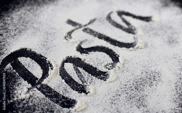 Obraz The inscription on the flour. Paste. Black background