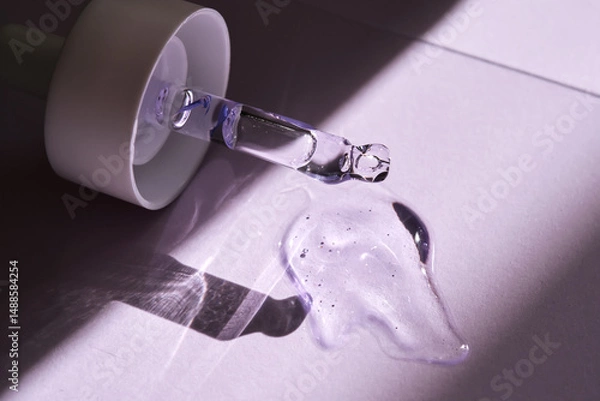 Fototapeta Pipette with serum on purple background with sunlight.