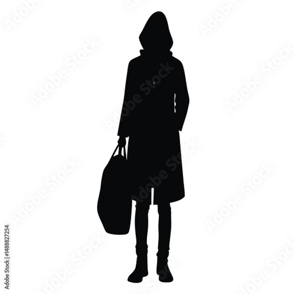 Fototapeta Silhouette of Person Wearing Coat and Hood, Holding Large Bag with One Hand