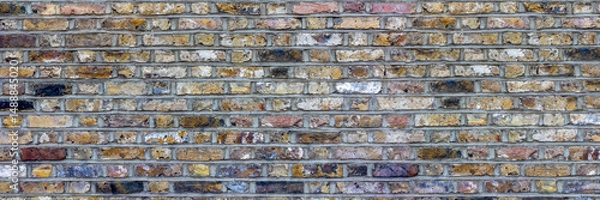Fototapeta Rustic Multicolored Brick Wall Texture with Weathered Vintage Appeal, banner, panorama