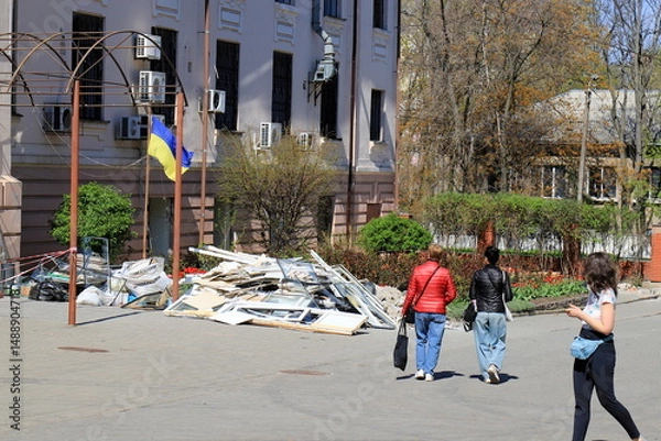 Obraz War in Ukraine. Broken windows in a destroyed house after a rocket attack on a medical university