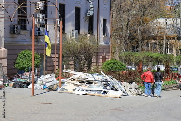 Obraz War in Ukraine. Broken windows in a destroyed house after a rocket attack on a medical university