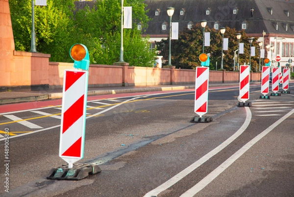 Obraz Repair of a road in the city. There are warning signs on the road.