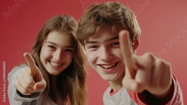 Fototapeta Happy Teenagers Pointing and Smiling at Camera