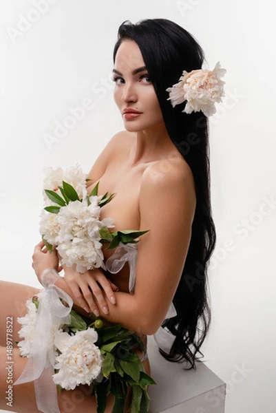 Fototapeta Brunette beauty adorned with flowers in a serene natural setting