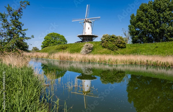 Obraz Reflections of a traditional windmill in the colorful countryside surrounding Veere, Zeeland, Netherlands