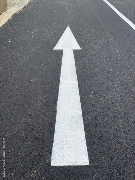 Obraz White arrow on a freshly paved street