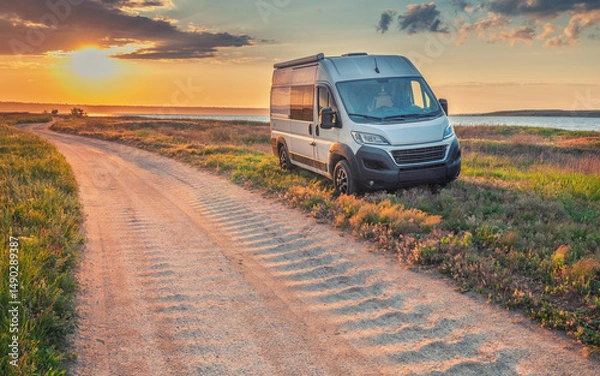 Obraz landscape with ground road on coast and white camper van in sunset time