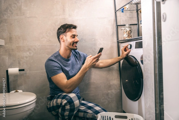Fototapeta Man Using Washing Machine