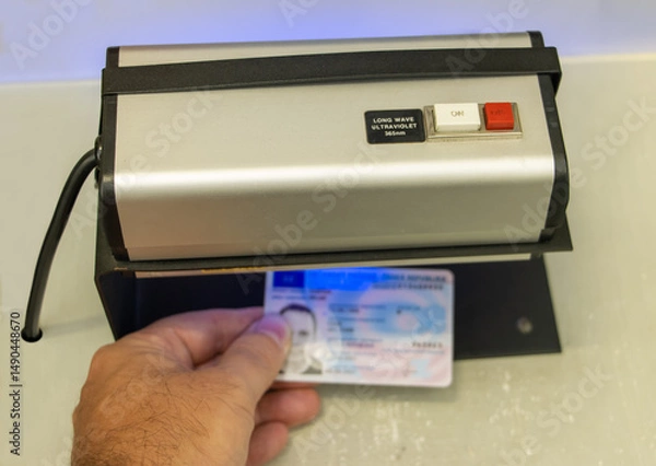 Obraz Verification of the validity of a personal identification document under ultraviolet light