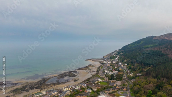 Fototapeta Aerial view of coast of Irish Sea and Mourne Mountains in Newcastle, Northern Ireland. Drone photo of Coastal City and water. 