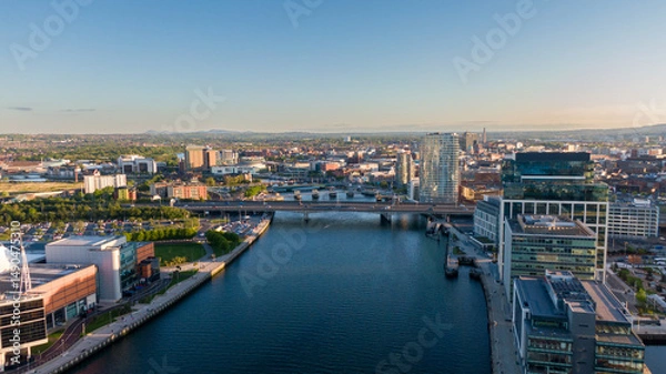 Fototapeta Aerial view on Lagan River and buildings in City centre of Belfast Northern Ireland. Drone photo, high angle view of town
