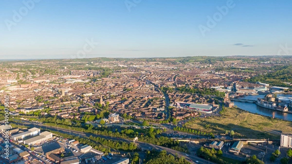 Fototapeta Aerial view on Lagan River and buildings in City centre of Belfast Northern Ireland. Drone photo, high angle view of town