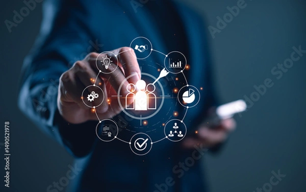Fototapeta Businessman using digital interface to target customers. Marketing strategy, customer relationship management (CRM), data analytics and business growth through technology.