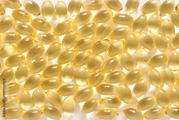 Obraz Many transparent orange colored oval shaped capsules scattered on a white background, omega 3 fish oil, lecithin, vitamin D