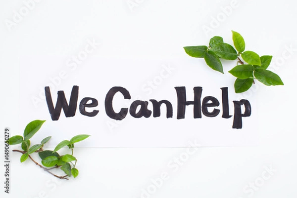 Fototapeta We Can Helpの手書き文字と緑の葉